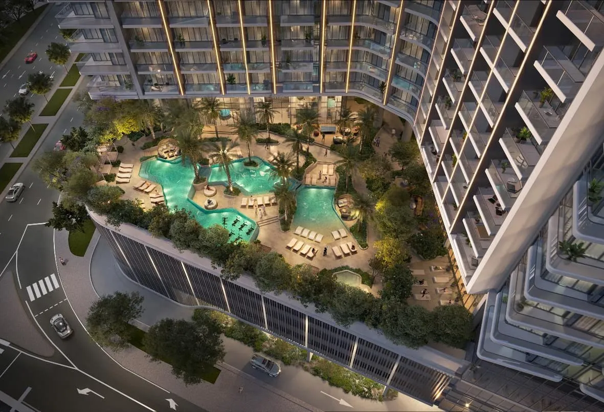 Render of the podium pool deck from above, a free-form pool among palm trees