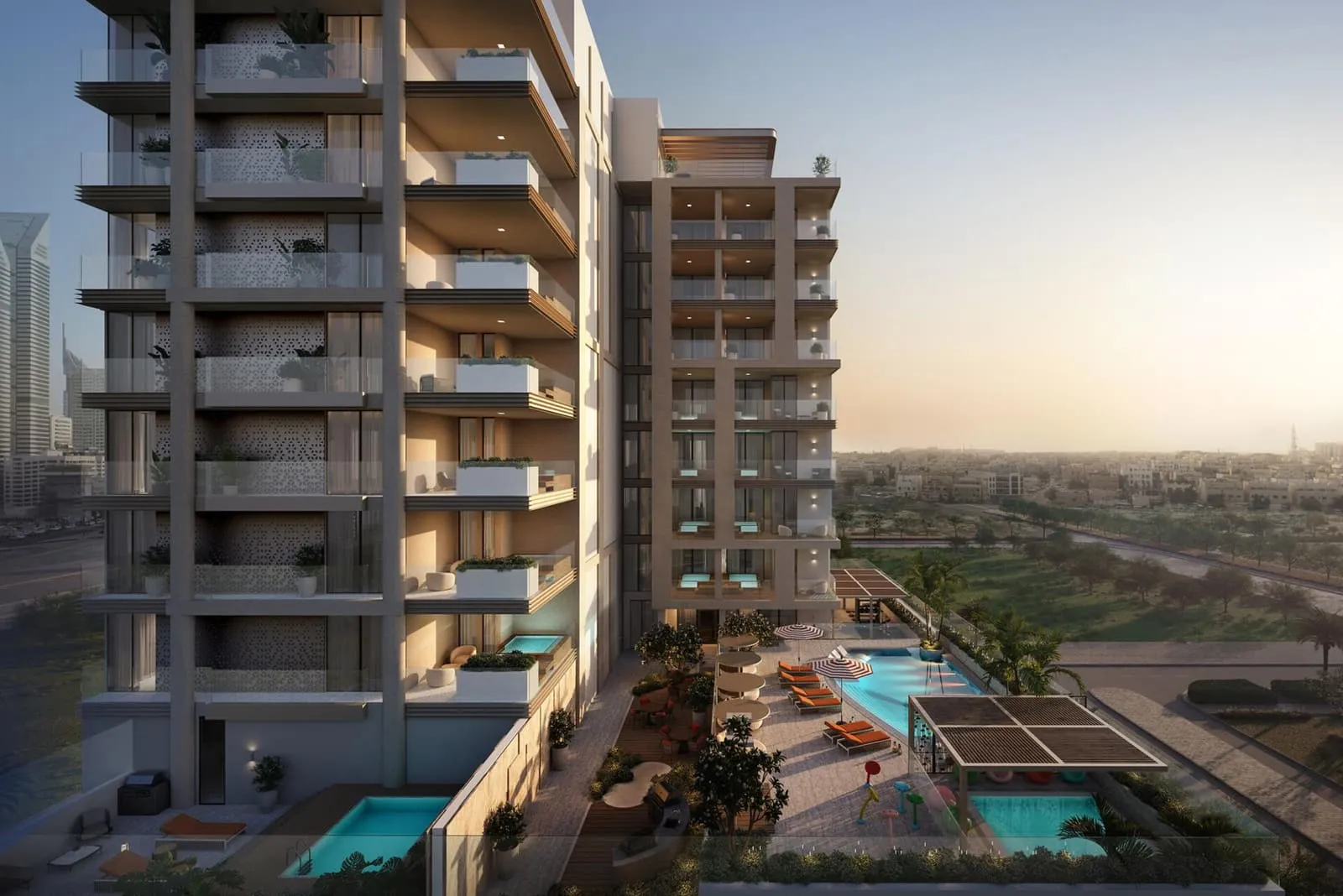 The podium pool deck at sunset, held between two wings of the building with loungers along the water