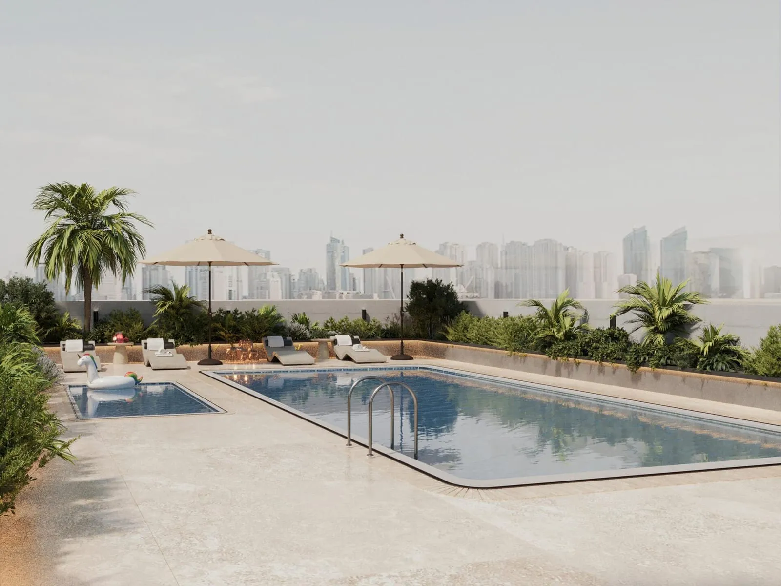 The outdoor pool in daylight, two parasols and loungers along the deck with palms and distant towers behind
