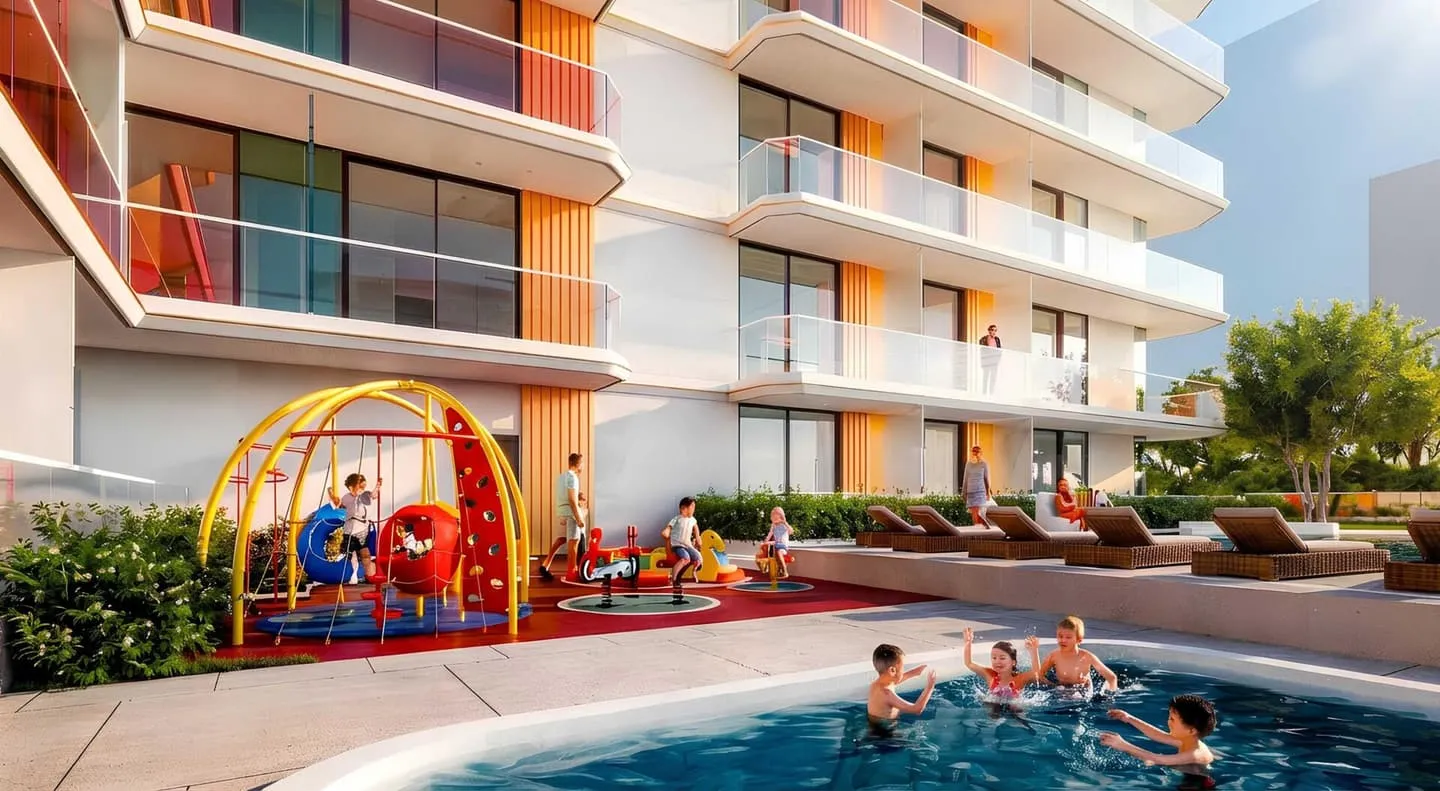 The pool beside the children's play area, its climbing frame and slide set against the balconies