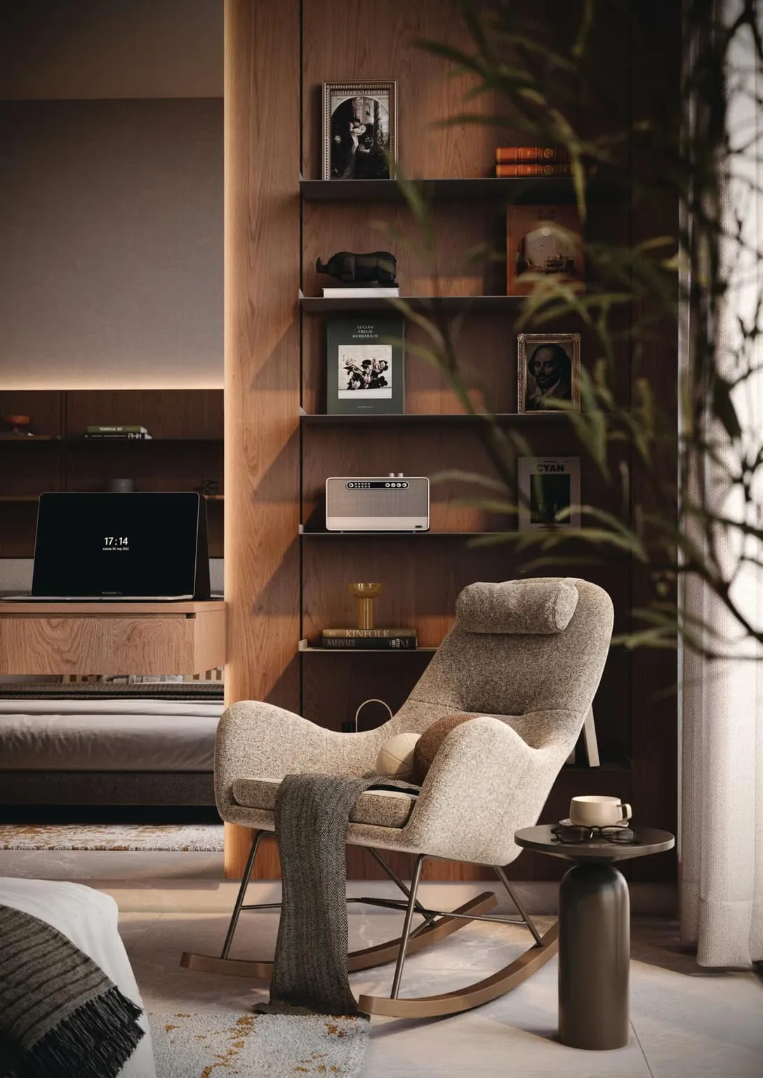 A rocking chair and side table in front of a lit bookshelf, the bed beyond it