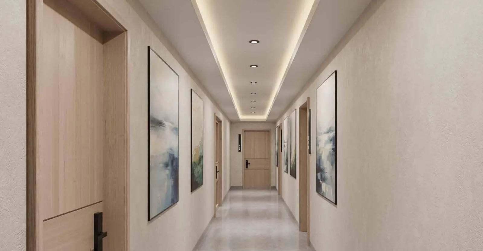 A residential corridor with timber apartment doors, framed artwork and a lit ceiling cove