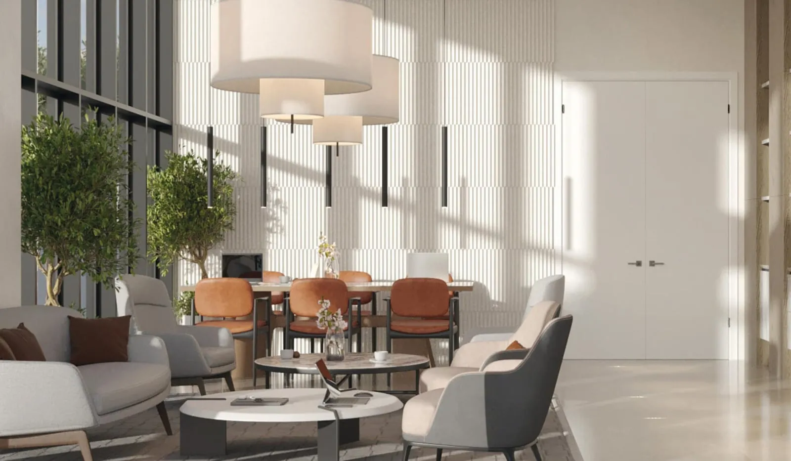 A residents' lounge, armchairs and small tables under drum pendants beside a full height window