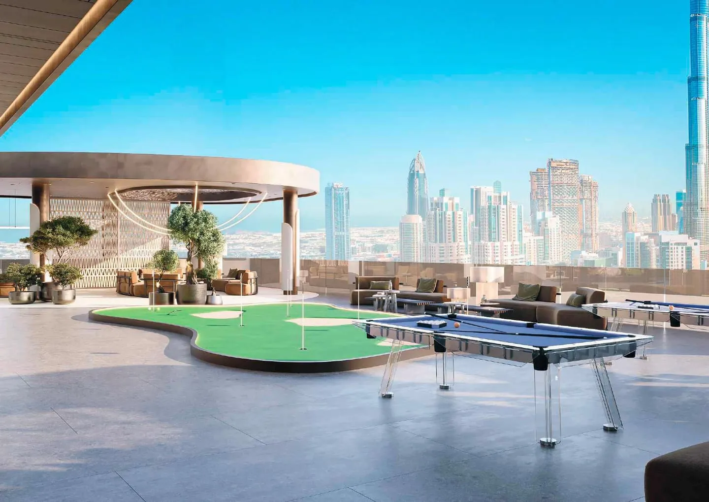 The rooftop games deck, a putting green and a table tennis table with the Downtown skyline behind