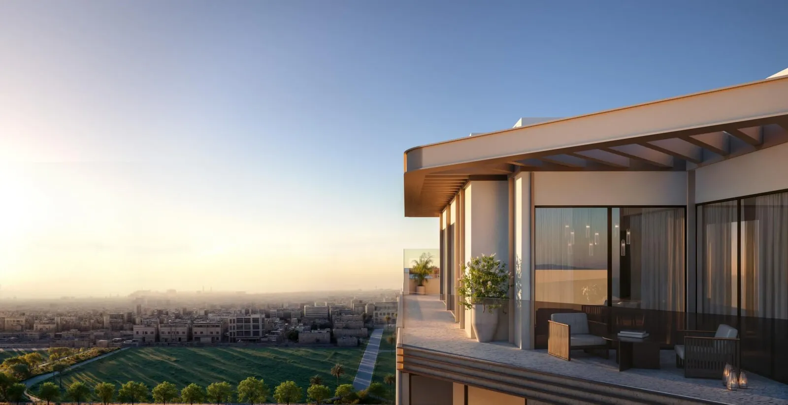 A rooftop lounge under a timber ceiling at sunset, glazed on two sides and open to fields and low-rise streets