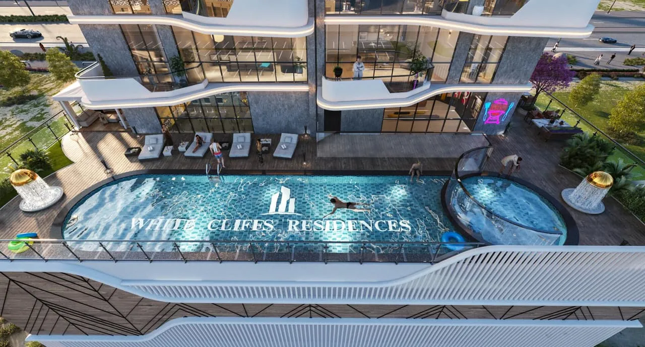 Aerial view of the swimming pool deck, branded with the Whitecliffs Residences name