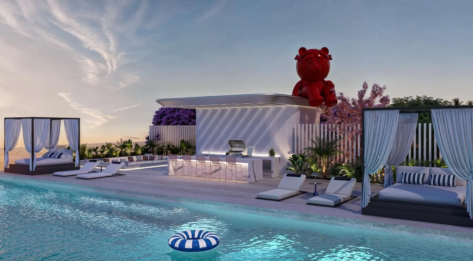 The rooftop pool deck by day, sun loungers and a shaded cabana beside the red bear sculpture