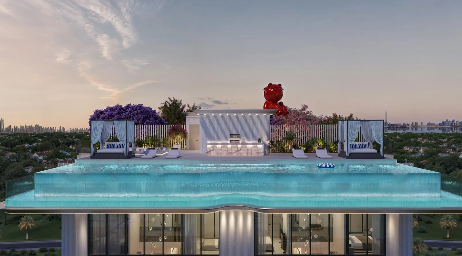 The rooftop infinity pool at dusk, cabanas and the red bear sculpture against the skyline