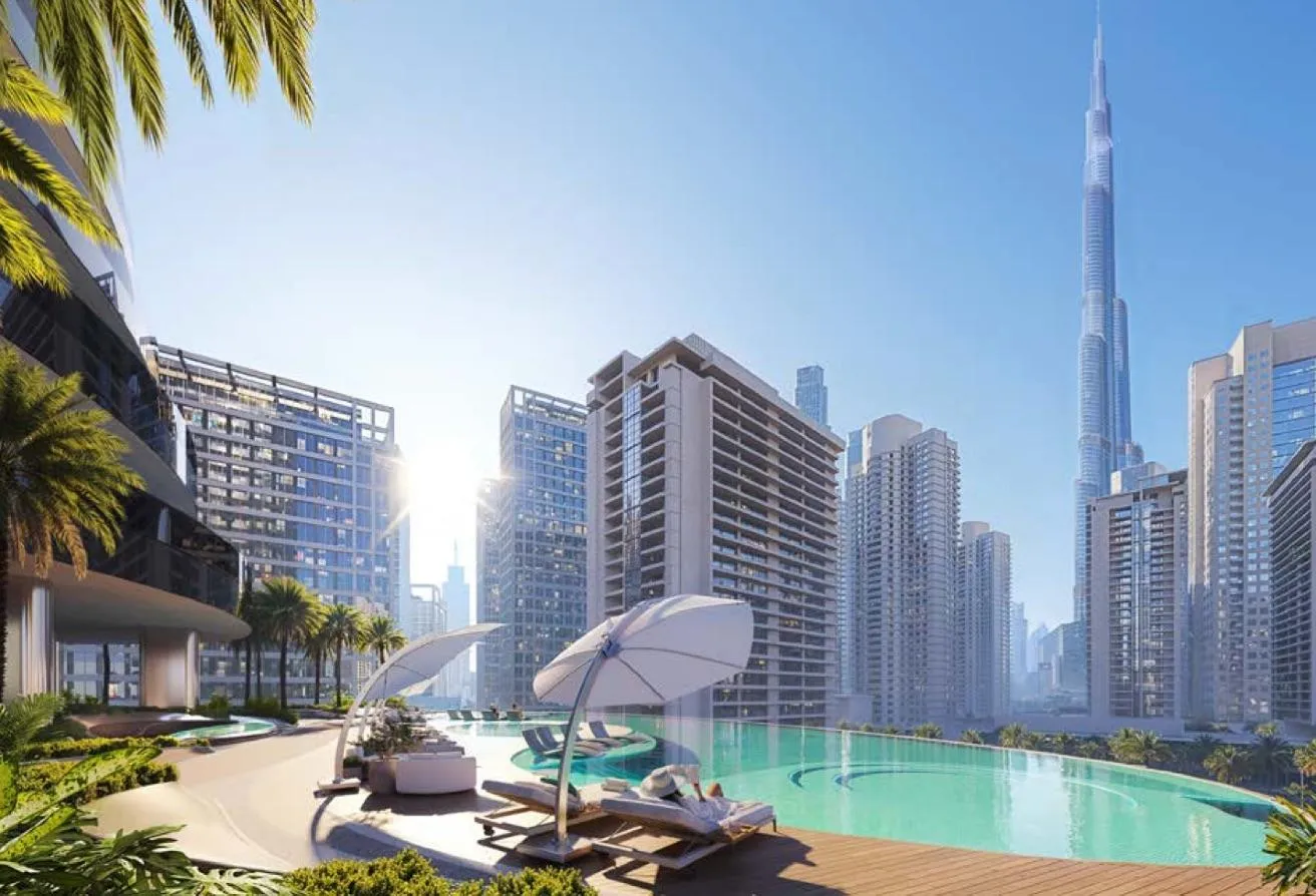 Render of an infinity pool with sun loungers and umbrellas, the Burj Khalifa on the skyline