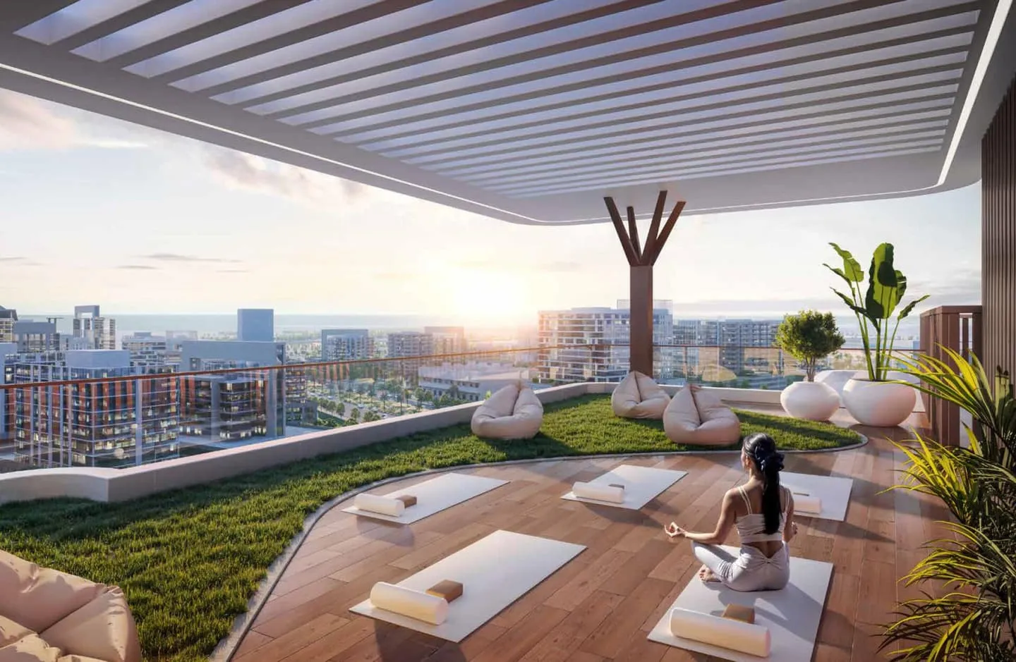 Yoga mats laid out on the rooftop deck at sunset, under a slatted canopy with the skyline behind