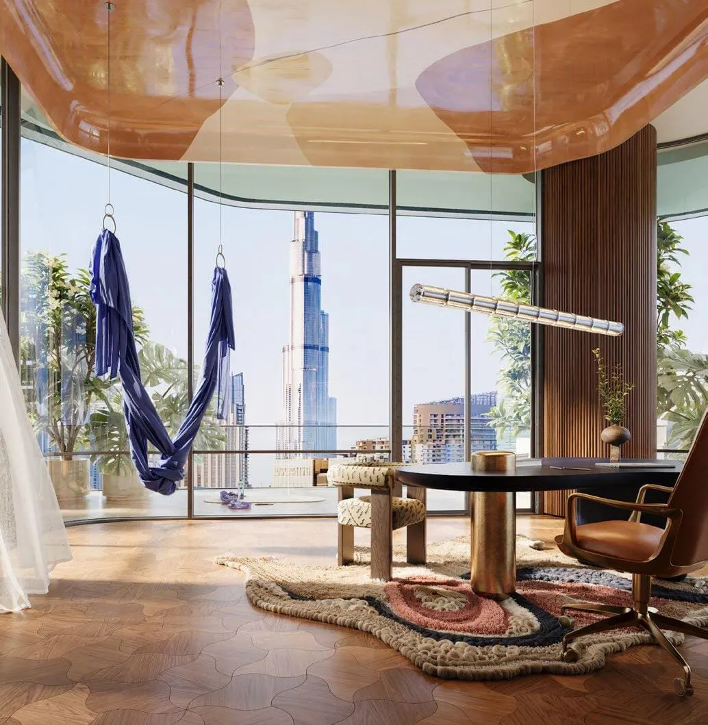 A hammock slung beside a round table at the window, the Burj Khalifa framed in the glass behind it