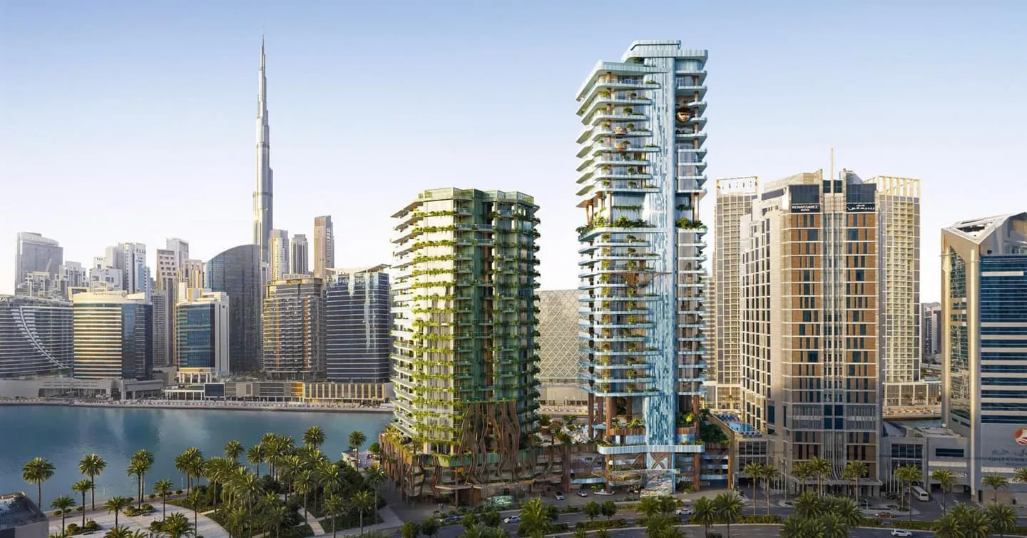 Seen from across the water, the towers sit among the Business Bay high-rises with the Burj Khalifa to the left