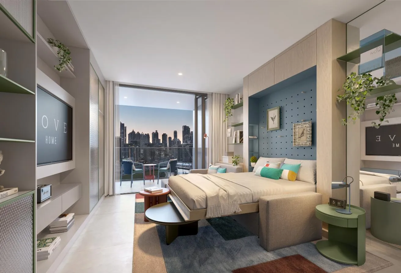 Render of the studio with a bed in front of a blue panelled wall, the skyline through the window