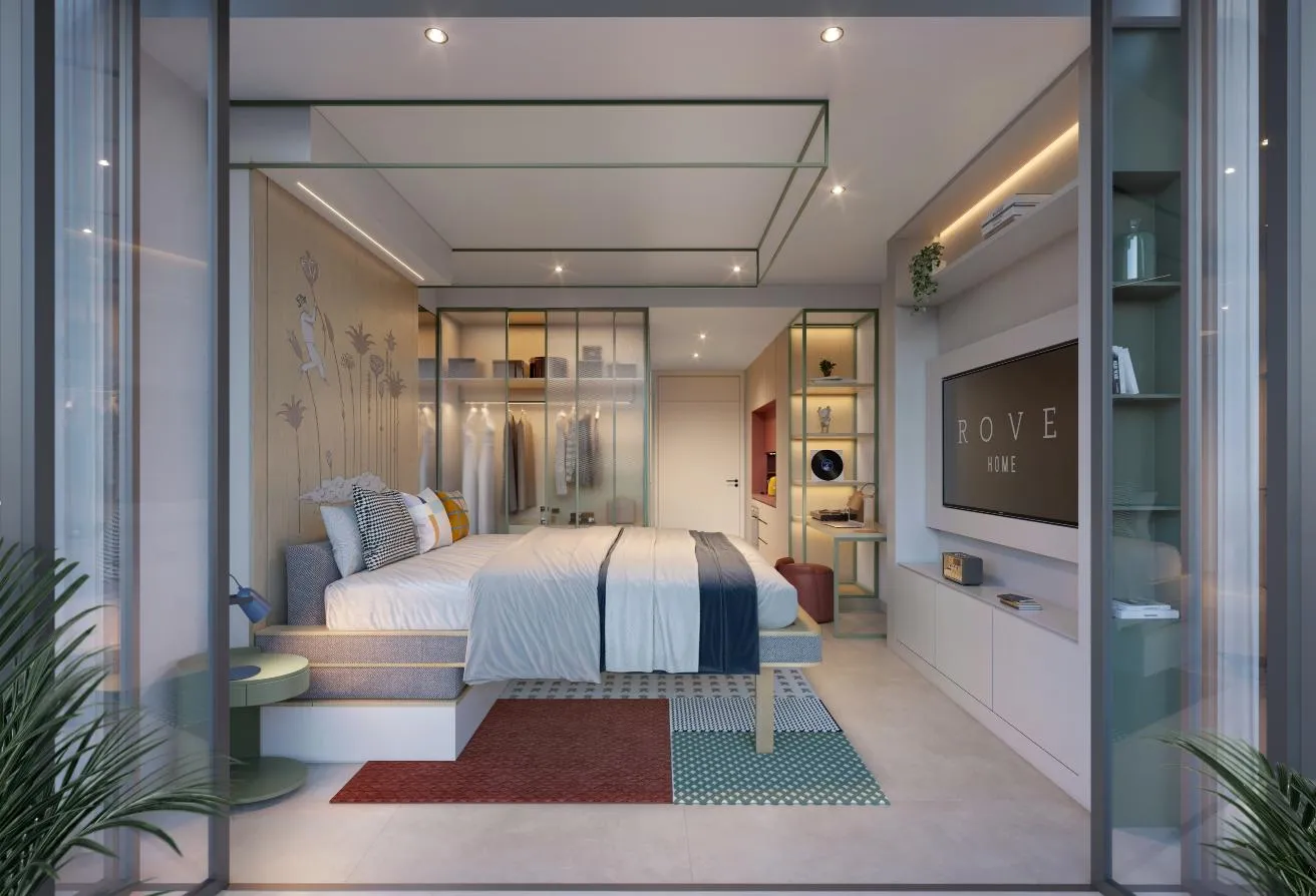 Render of the studio seen from the window, with the bed, a glass-fronted wardrobe and a wall screen