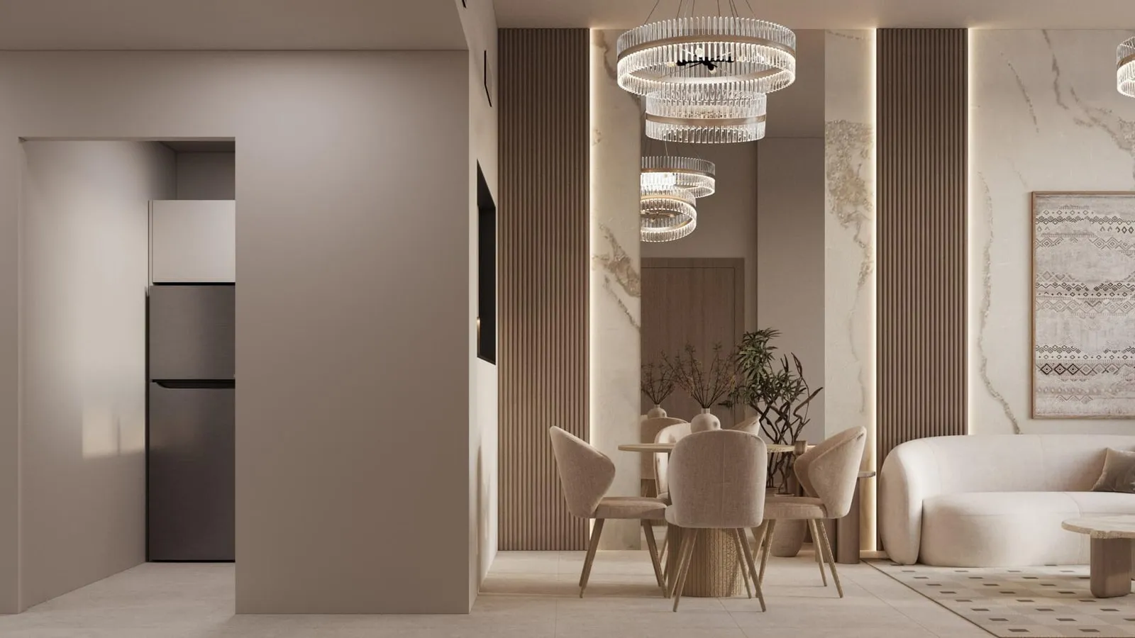 The studio from the entry hall, the dining table under a ring chandelier and the bed beyond a fluted partition