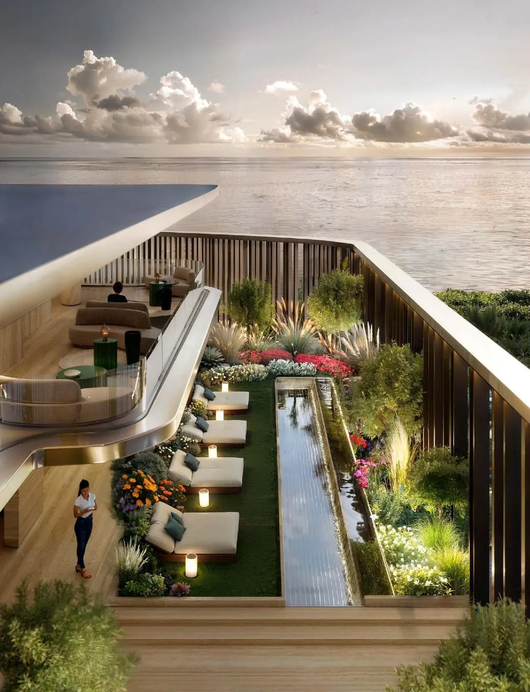 Sun loungers along a narrow water channel on the terrace, planting either side and the sea beyond