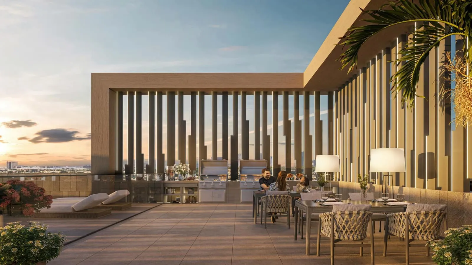 The rooftop terrace at sunset, a long dining table and barbecue counter set behind the fluted screen wall