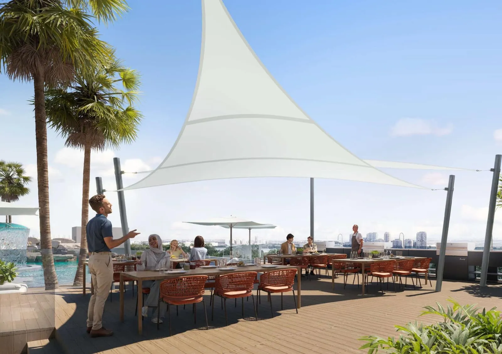 Residents at long tables on the shaded terrace, sail canopies overhead