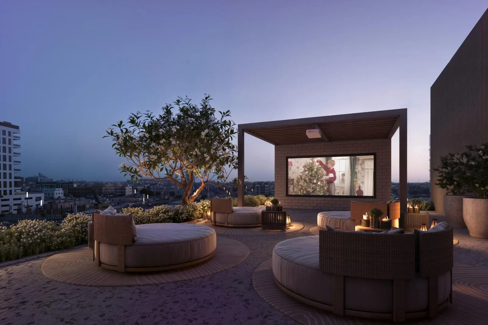 A terrace at dusk, curved seating around a fire table with planting screening the edge of the deck
