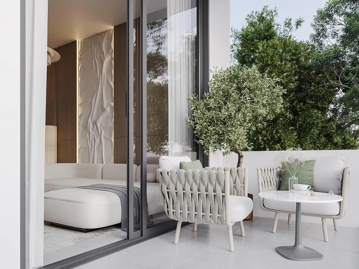 A terrace off the living room, sliding doors open onto planting and a paved seating area