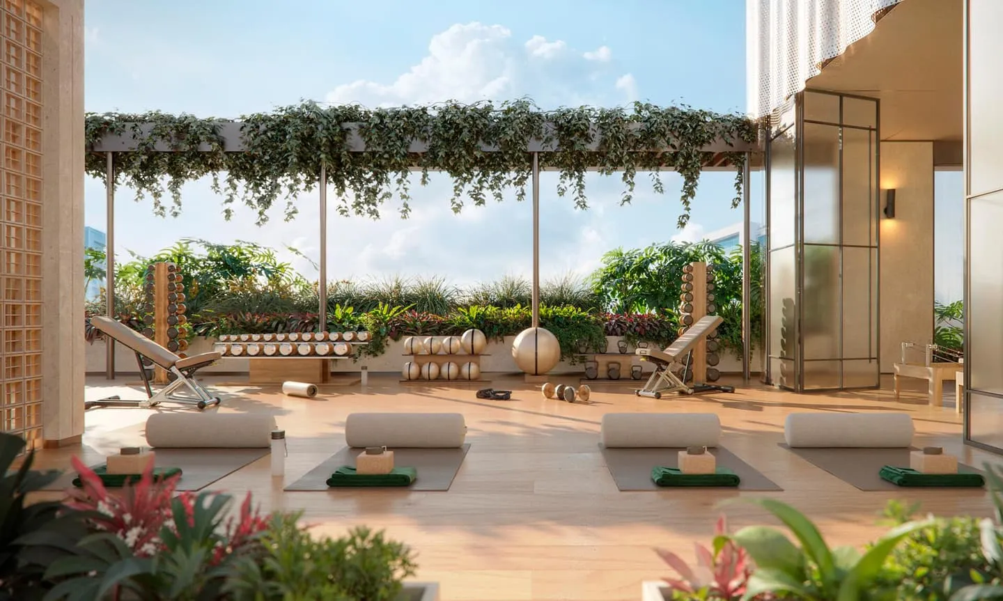Sun loungers on a terrace beneath a slatted pergola hung with trailing greenery
