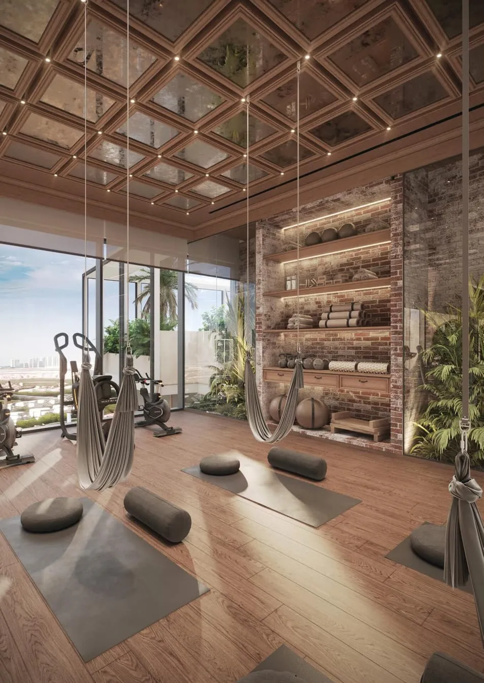 A yoga room with aerial hammocks, mats on the timber floor and rolled mats on a brick shelf wall